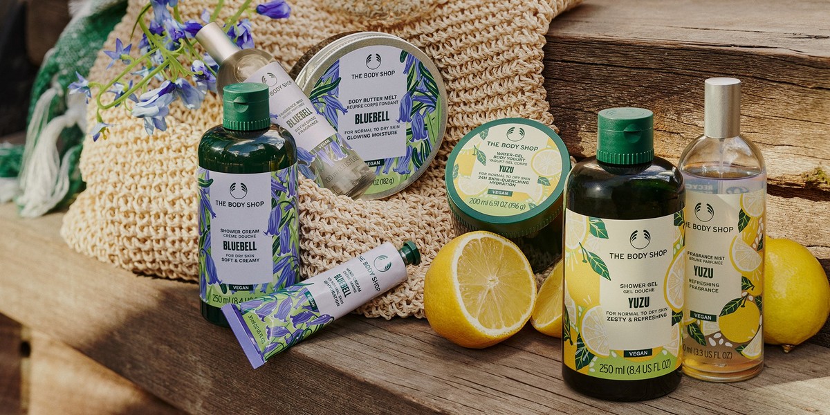 Yuzu and Bluebell body care products alongside a display of lemons and bluebells