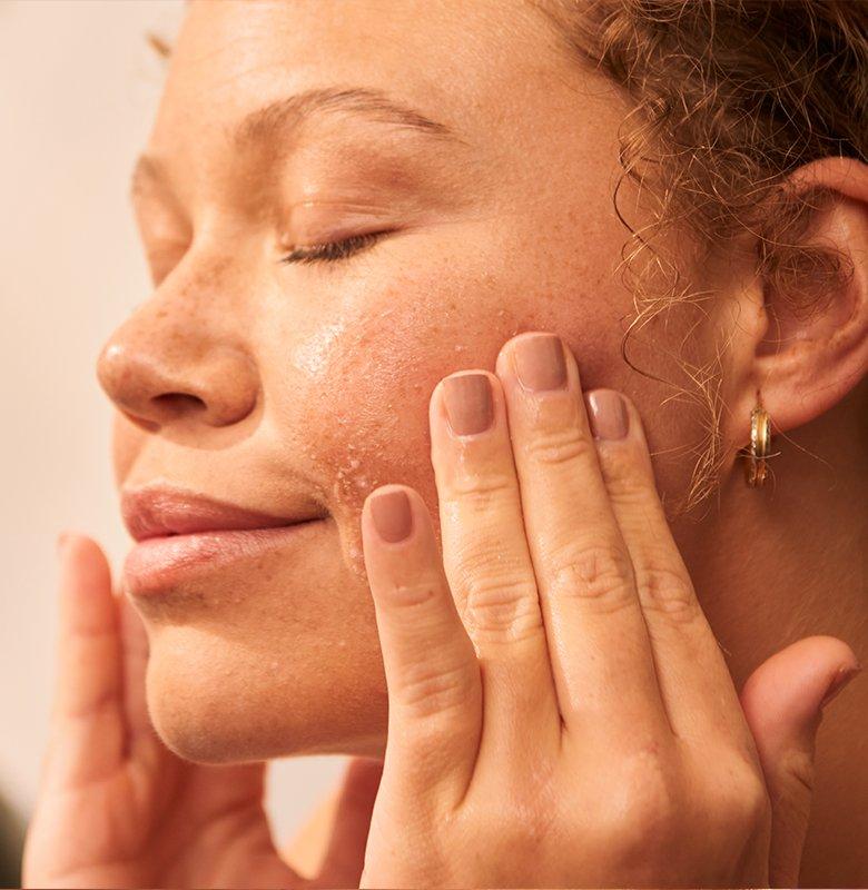 Lady cleansing her cheeks