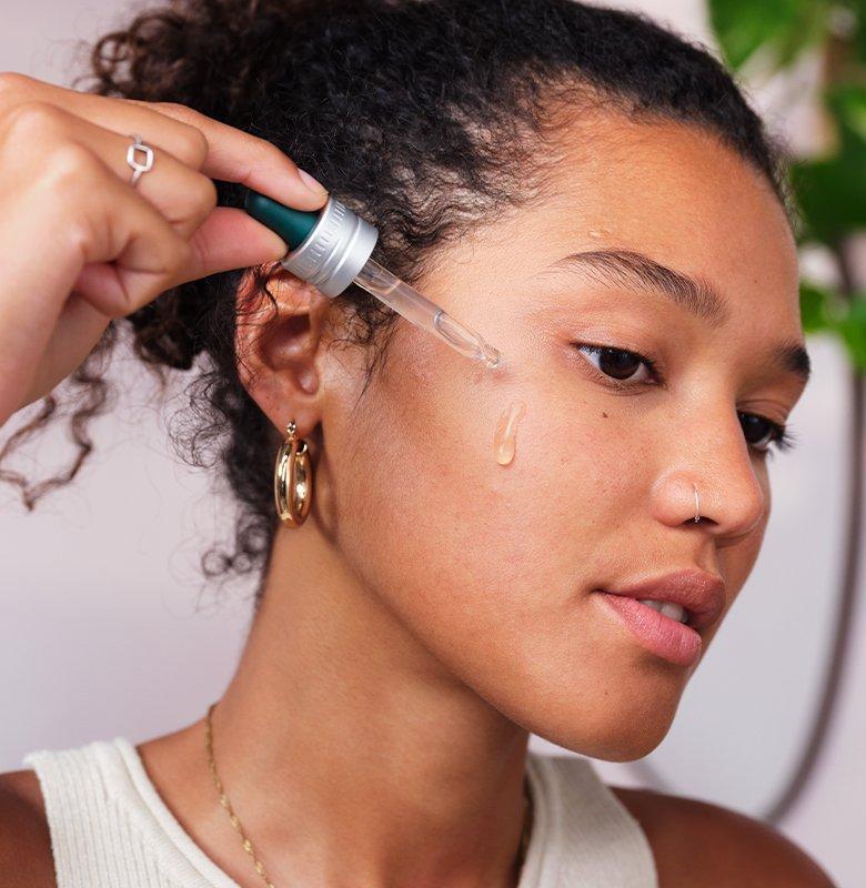 Drop of Edelweiss serum on lady's cheek