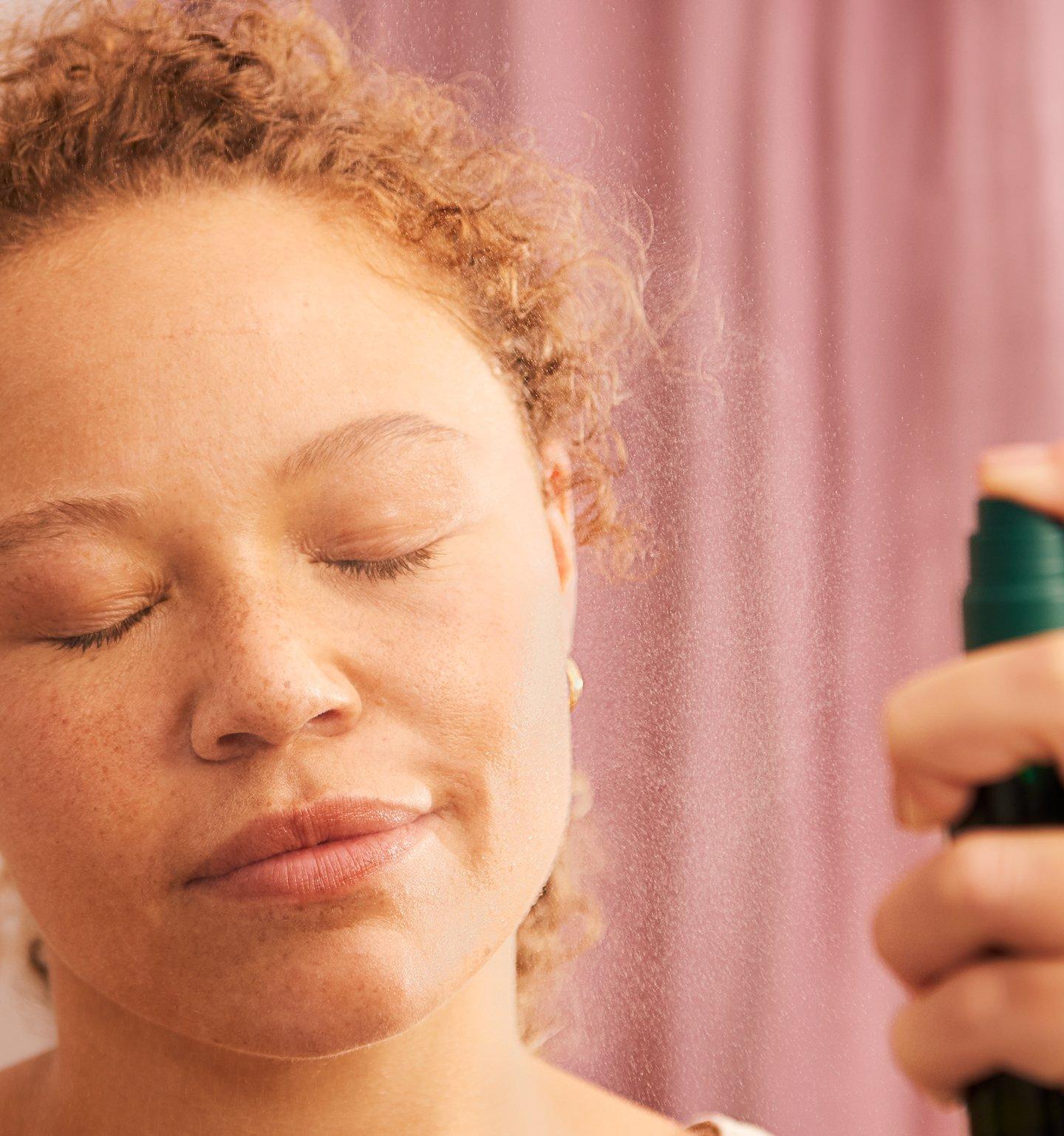 Spraying face from a bottle