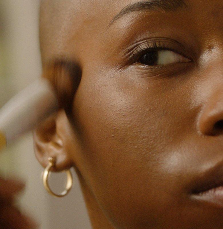 Woman applying foundation using brush