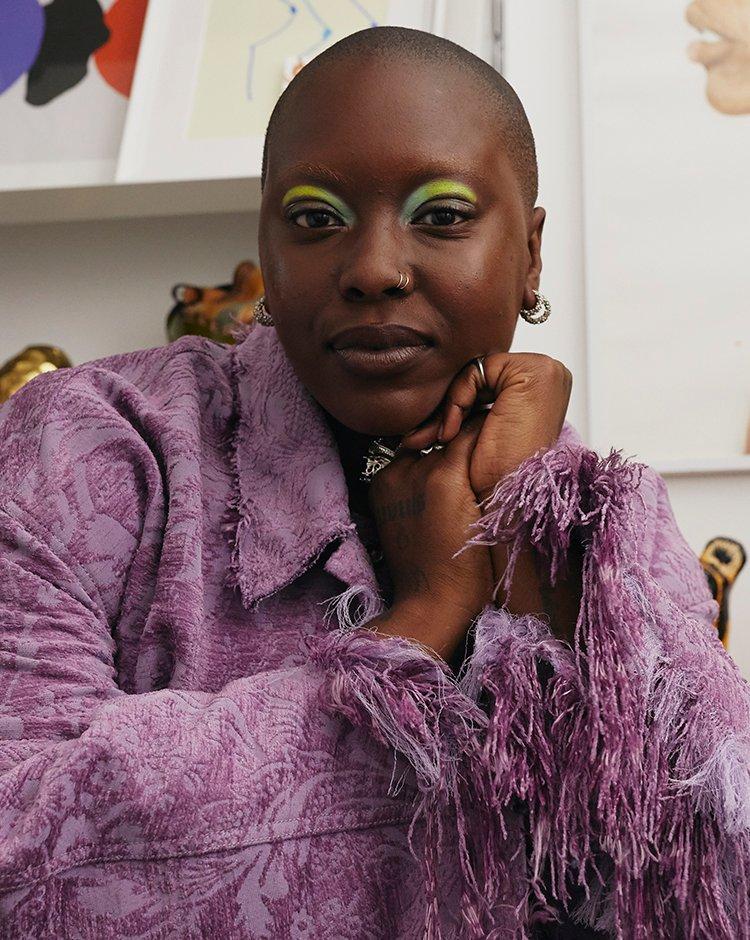 Activist Char Ellesse wearing a purple jacket