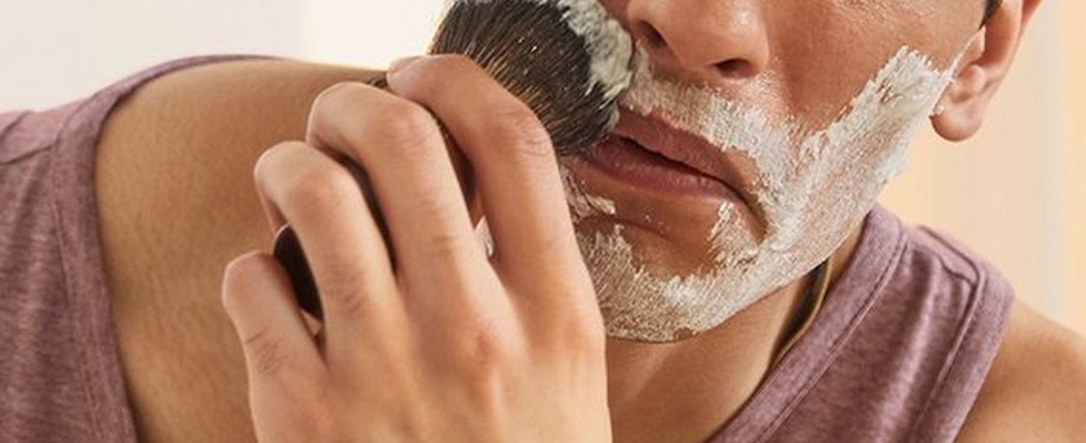 Man applying shave cream with a brush Man applying shave cream with a brush