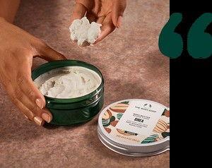 Model scooping Body Butter from tub Model scooping Body Butter from tub
