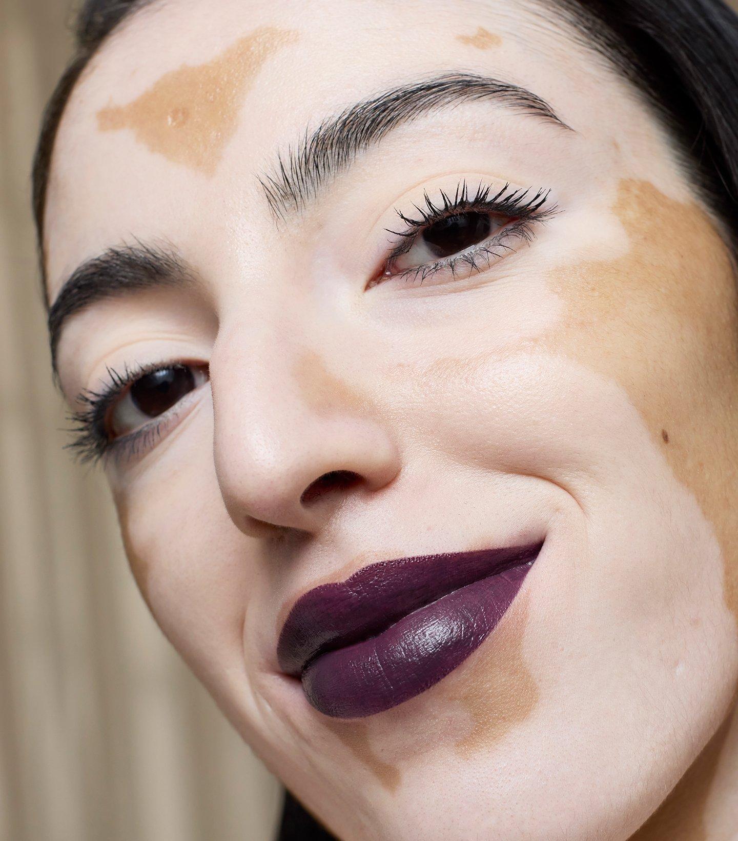 Model wearing plum colour lipstick