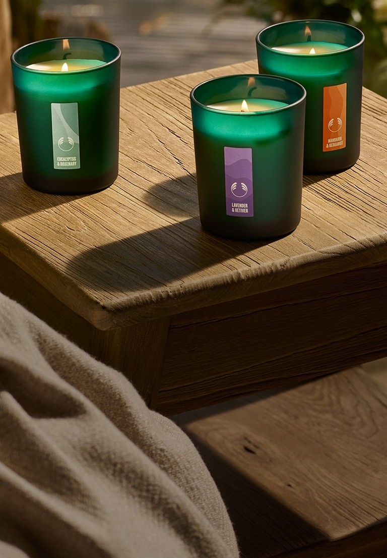 Image of three green candles on table