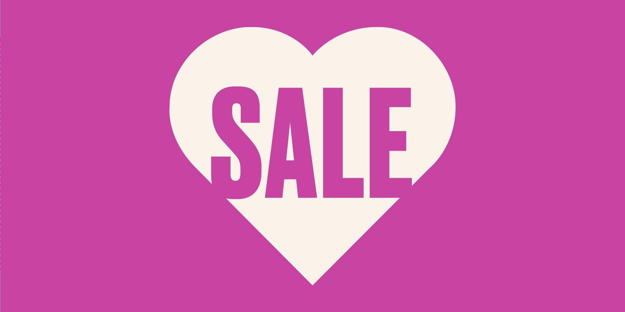 a heart shaped sale sign on a pink background