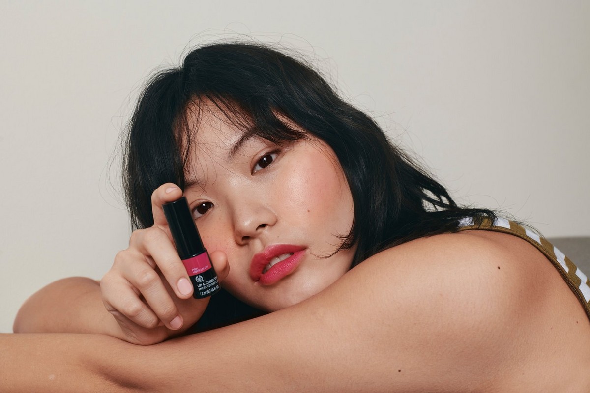 Woman holding lipstick
