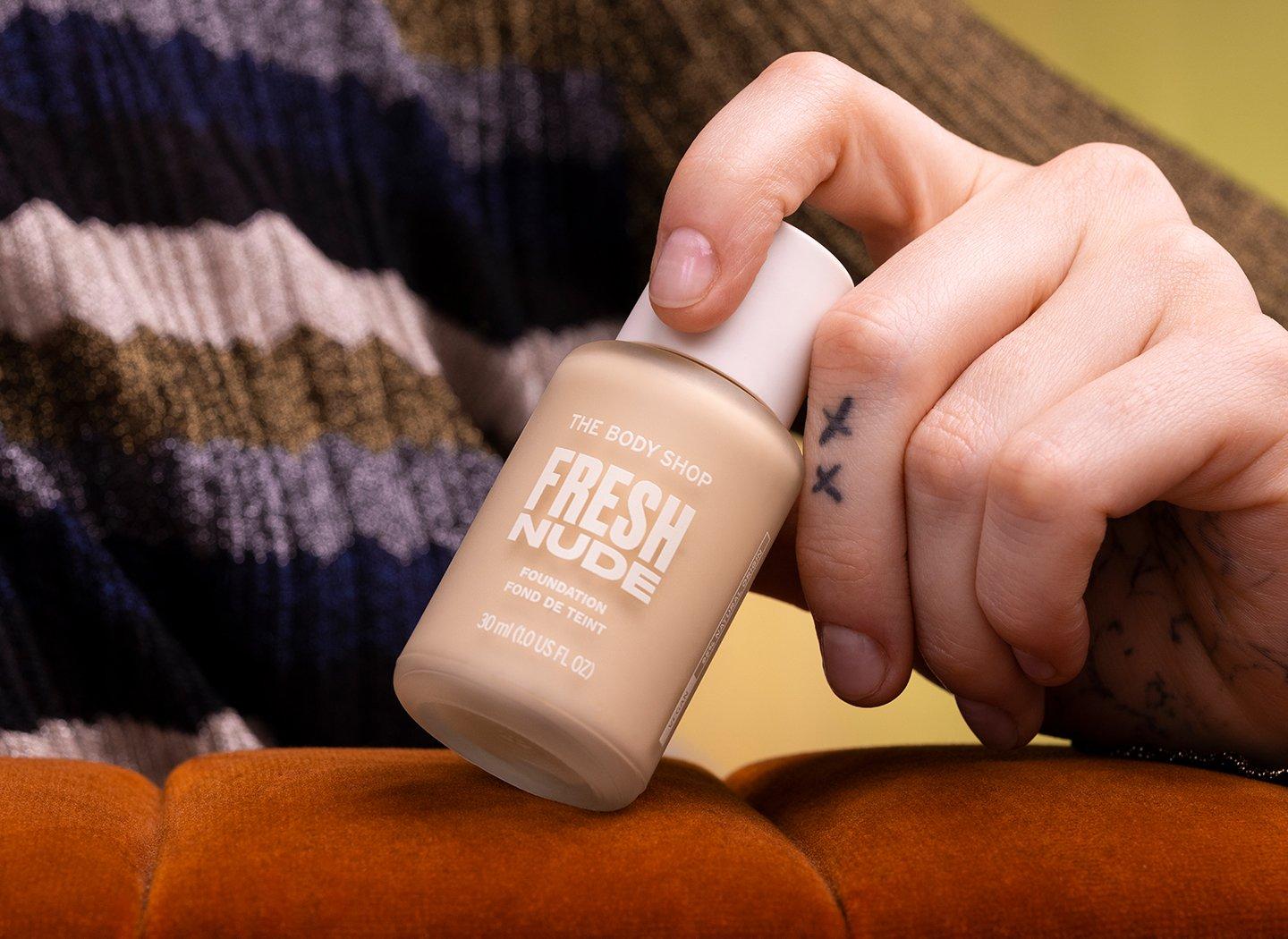 Person holding bottle of Fresh Nude foundation