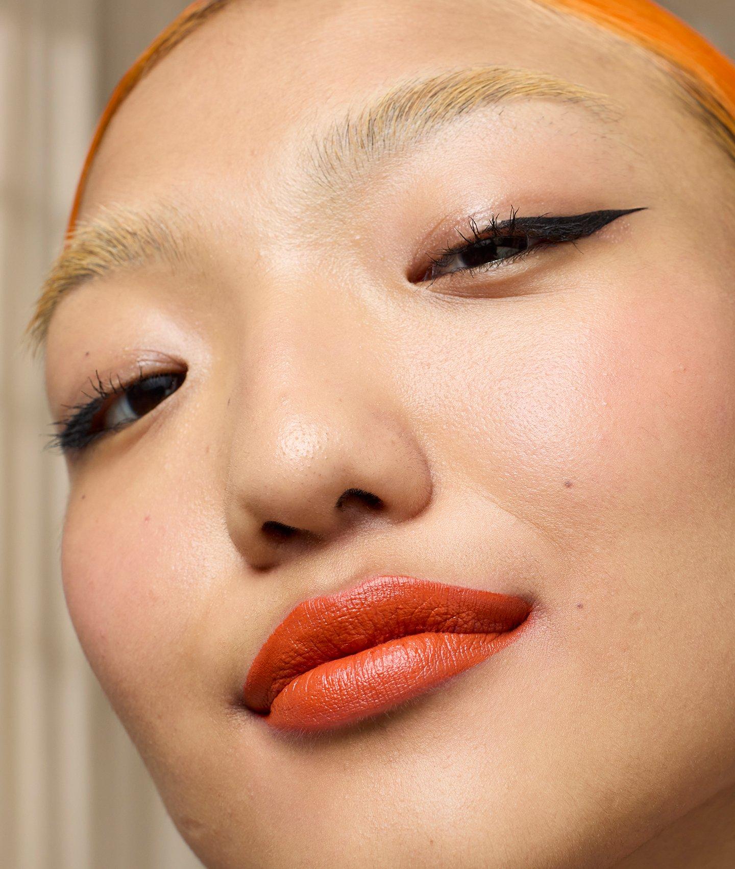 Model with orange lipstick shade