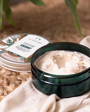 The Body Shop Coconut Body Butter on blanket The Body Shop Coconut Body Butter on blanket