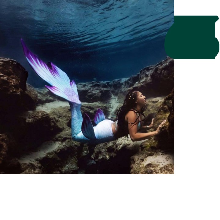 Woman swimming in mermaid costume Woman swimming in mermaid costume
