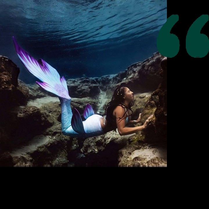 Woman swimming in mermaid costume Woman swimming in mermaid costume