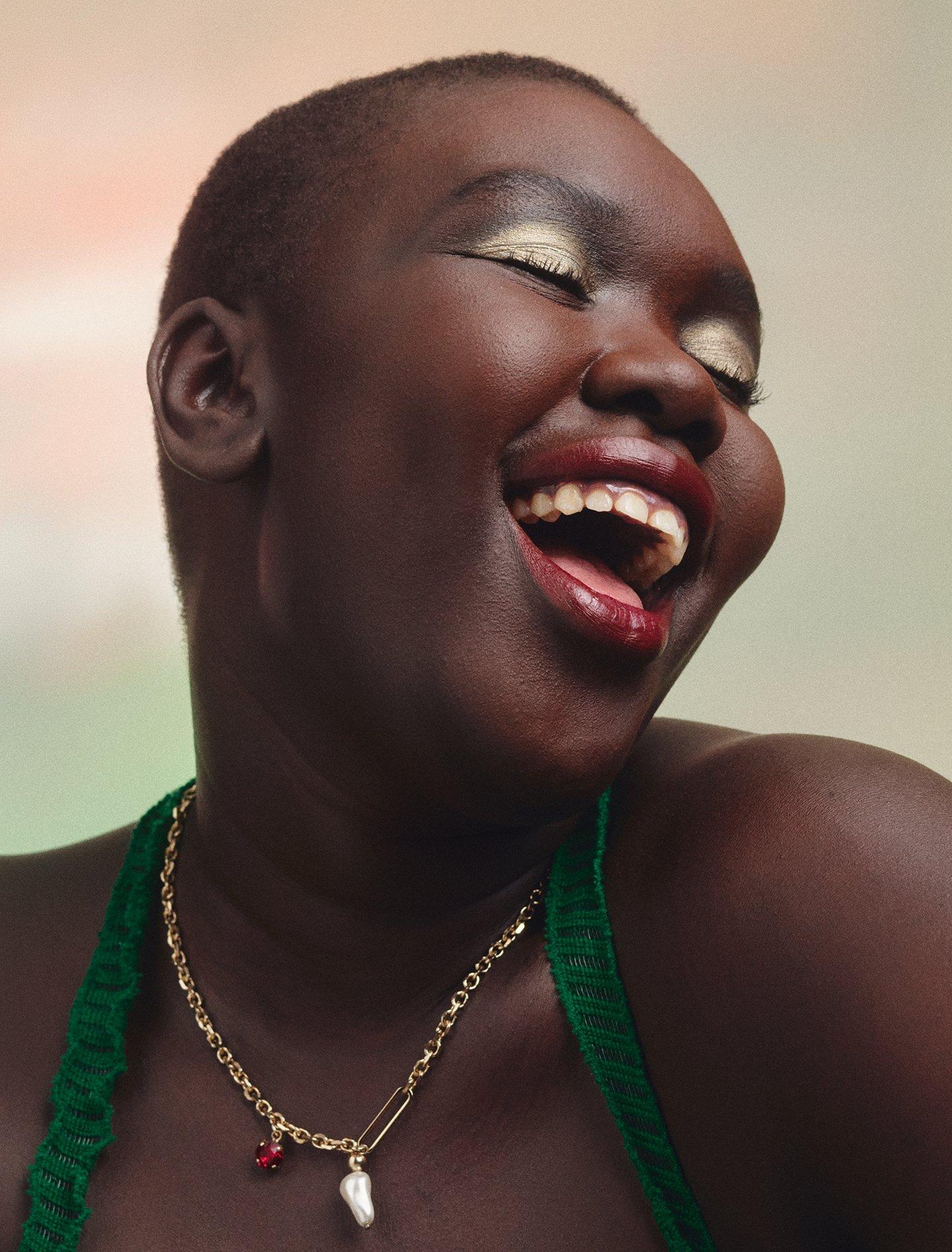 Model with red shade of lipstick on smiling