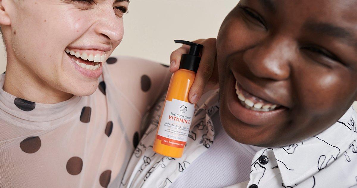 Two models laughing together, holding the Vitamin C Liquid Peel