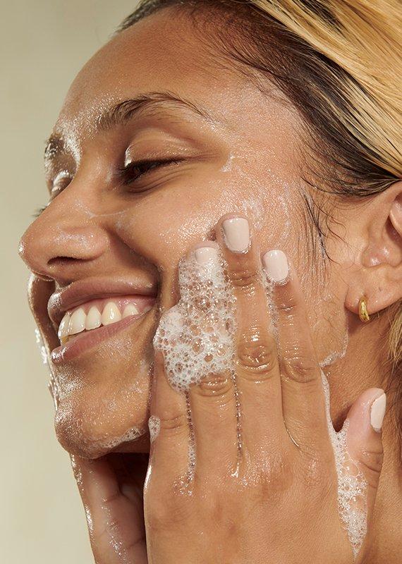 Woman cleansing face with face wash