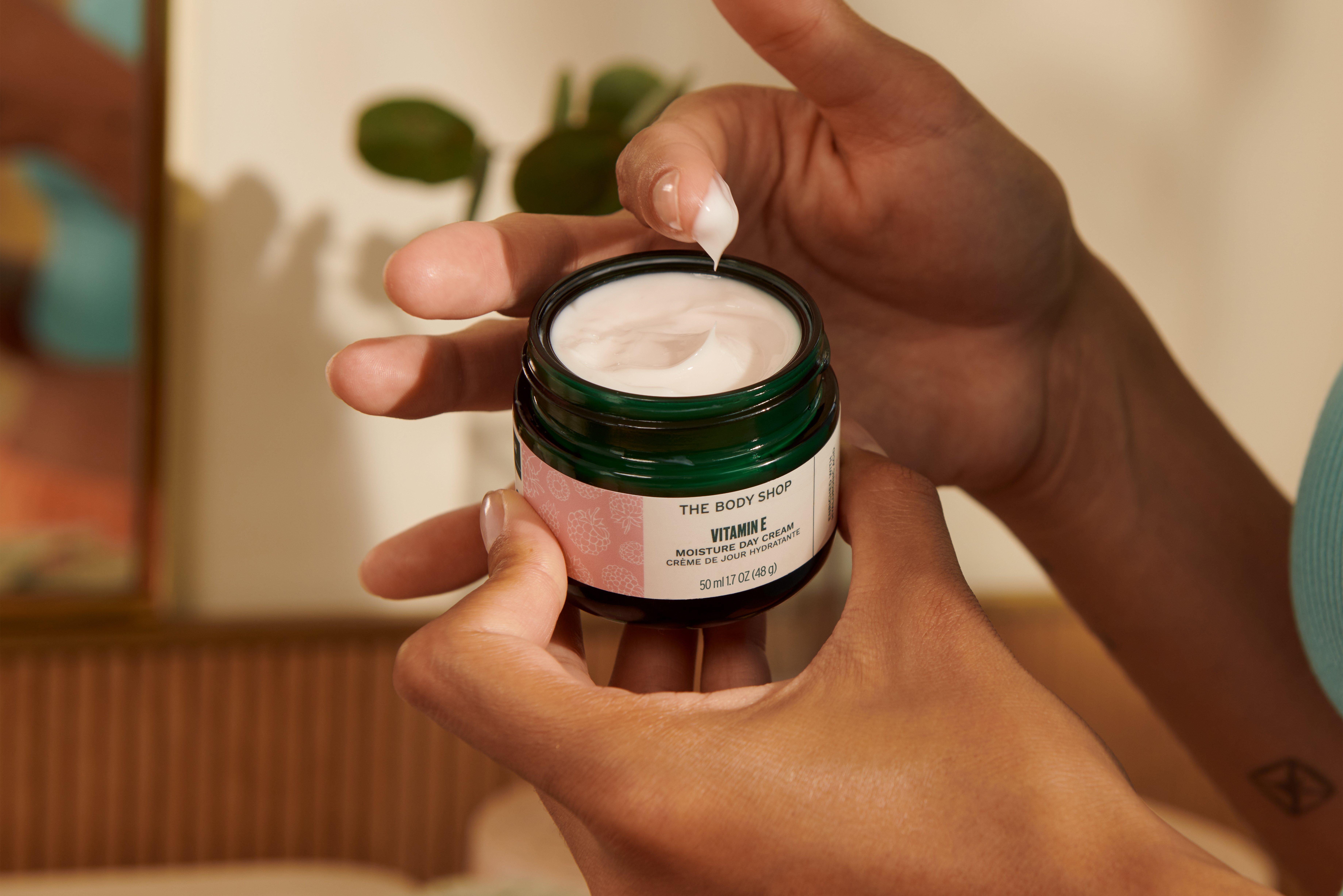 FINGERS IN POT OF THE BODY SHOP VITAMIN E CREAM