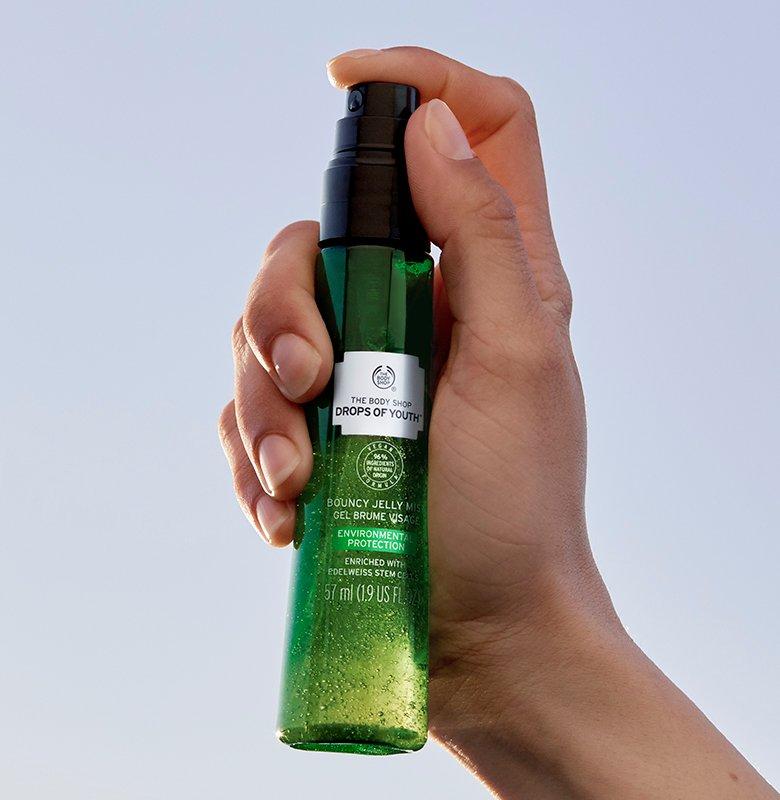 Drops of Youth Bouncy Jelly Mist being sprayed by a models hand