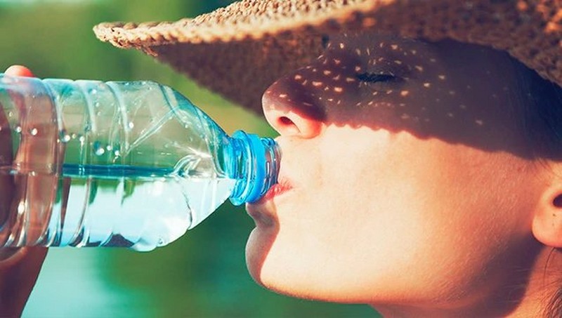 Woman drinking water from a bottle Woman drinking water from a bottle