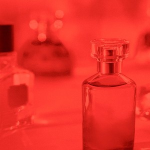 Selection of fragrance bottles with red filter overlay