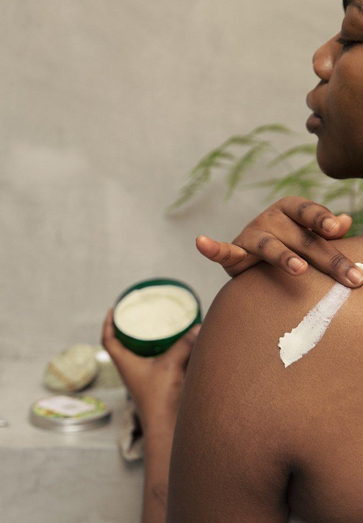 Person applying The Body Shop moisturizer