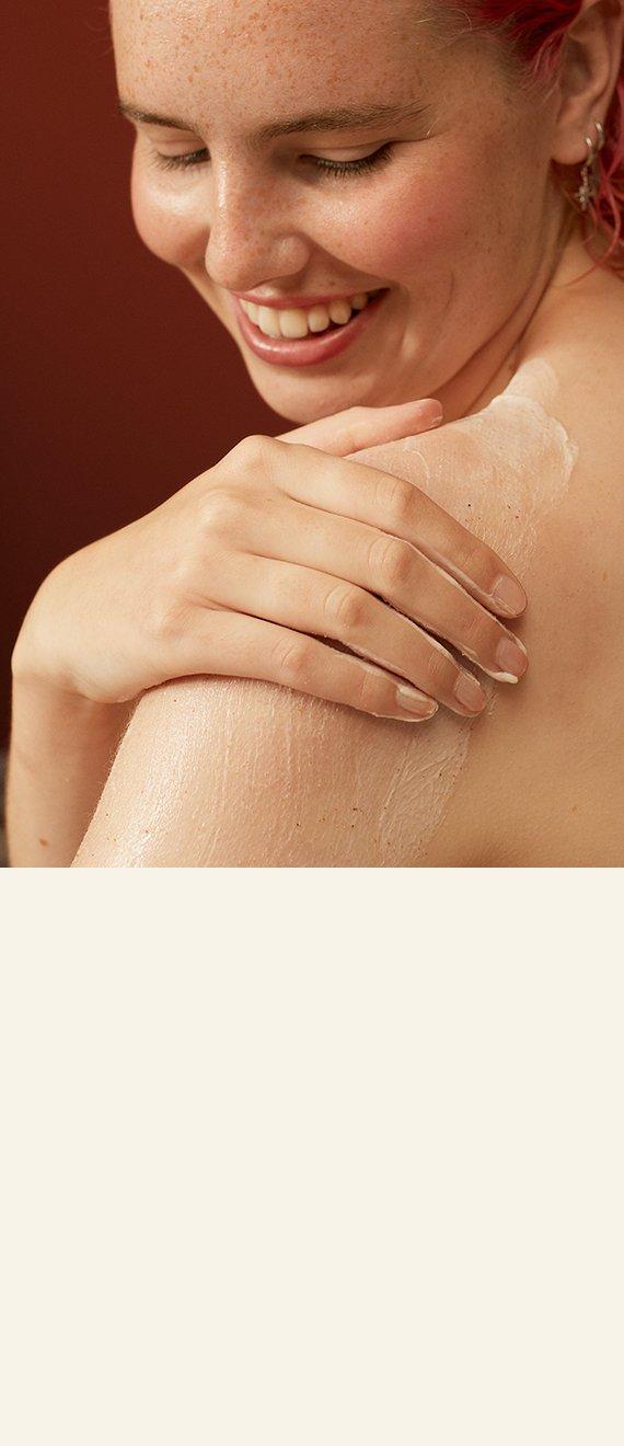 Model applying body scrub