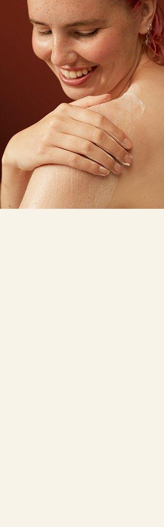 Model applying body scrub