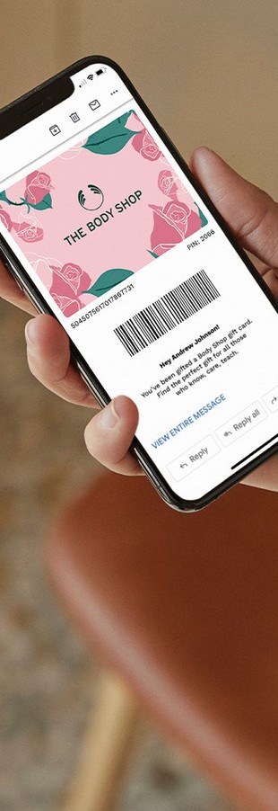 Person holding a smartphone with a Mother's Day e-gift card on the screen Person holding a smartphone with a Mother's Day e-gift card on the screen