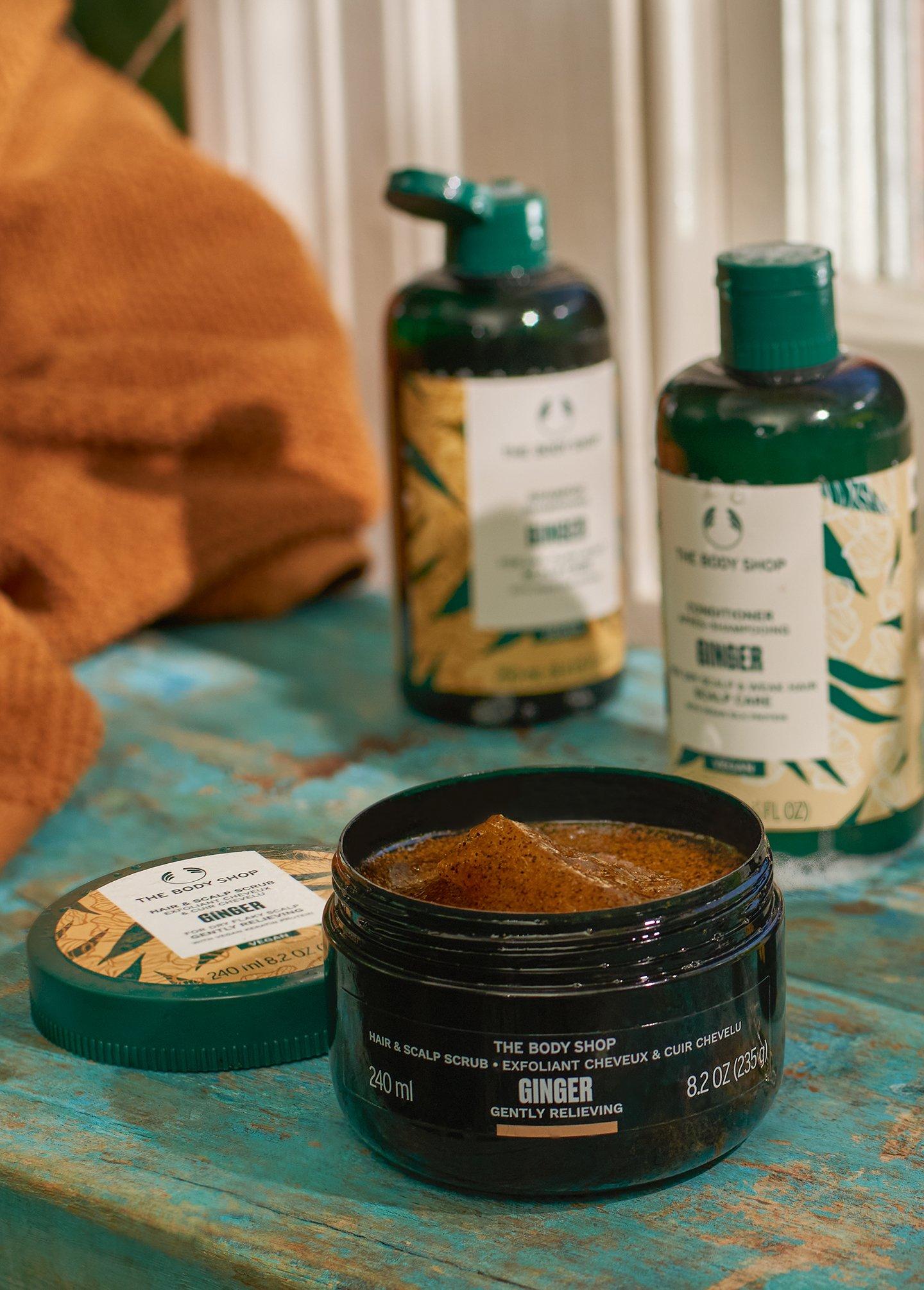 Bottle of The Body Shop Ginger Shampoo on a towel