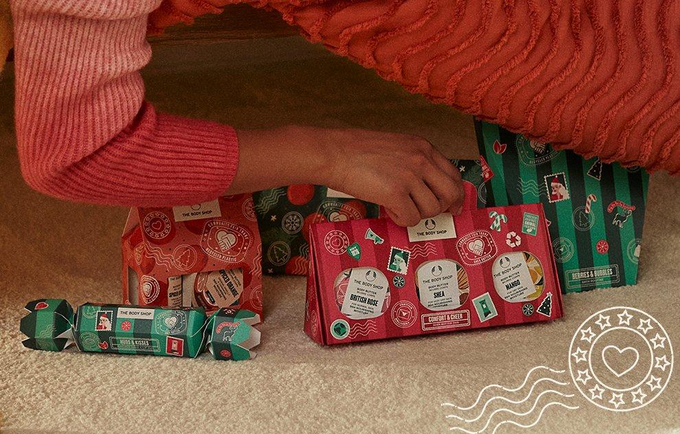 Image of woman picking up The Body Shop gifts