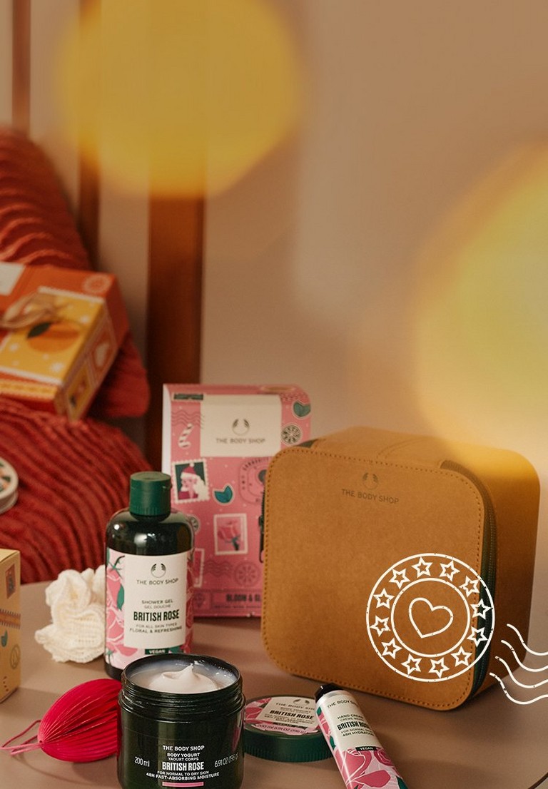 Image of various The Body Shop gifts and products, with Community Fair Trade illustrated postal image