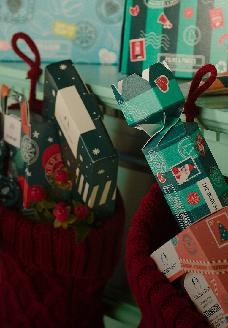 Image of stockings filled with gifts, hanging on the mantelpiece
