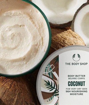 The Body Shop Coconut Body Butter tub on sink The Body Shop Coconut Body Butter tub on sink