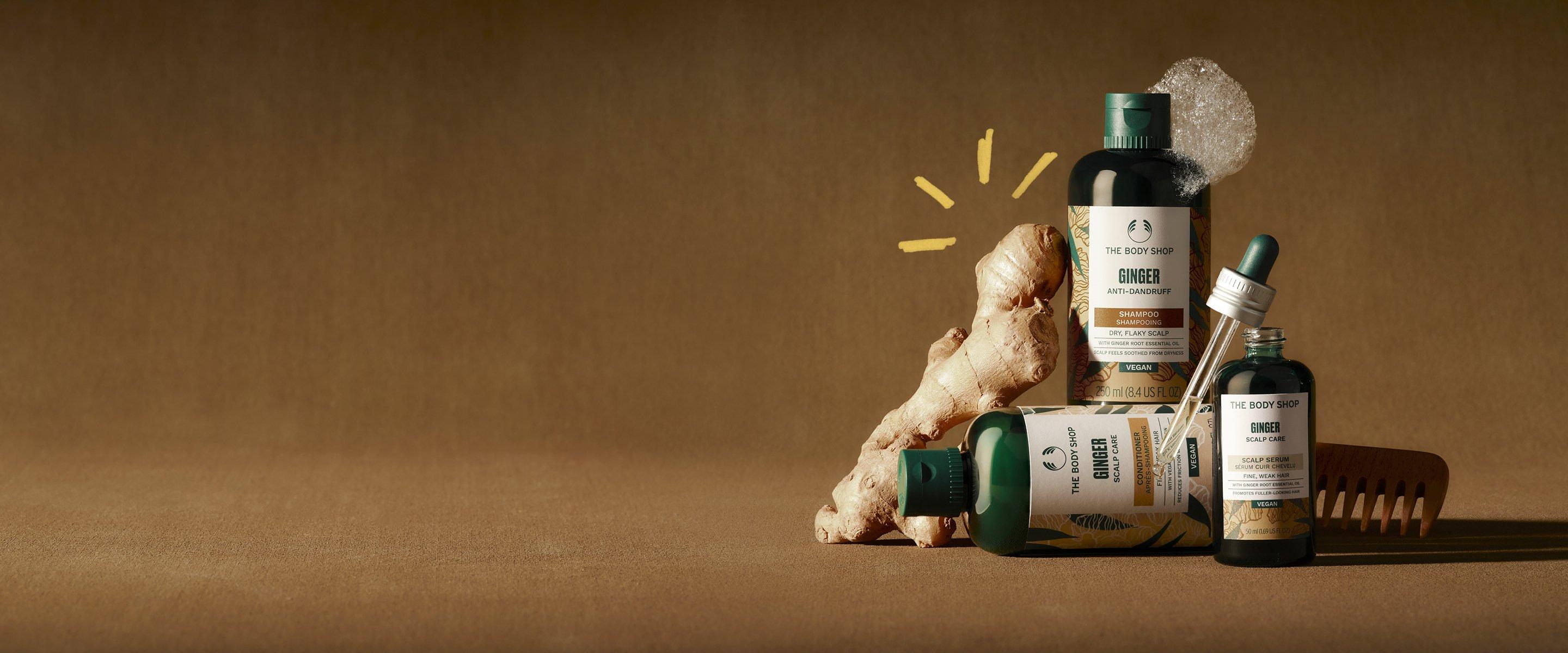 Image 19: A Ginger haircare range, a bottle of shampoo, a bottle of conditioner and a serum on a table with ginger