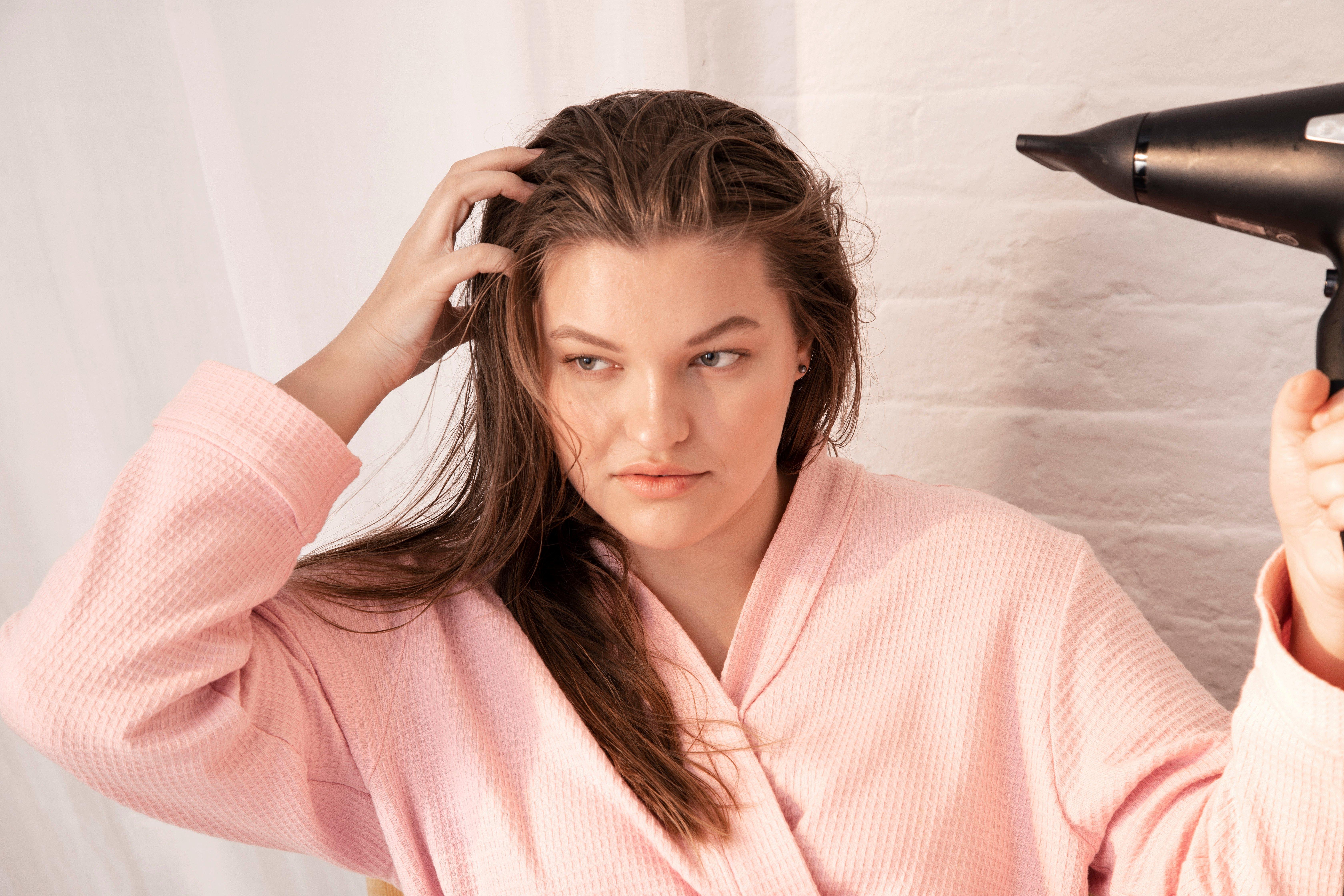 Woman blow-drying her hair