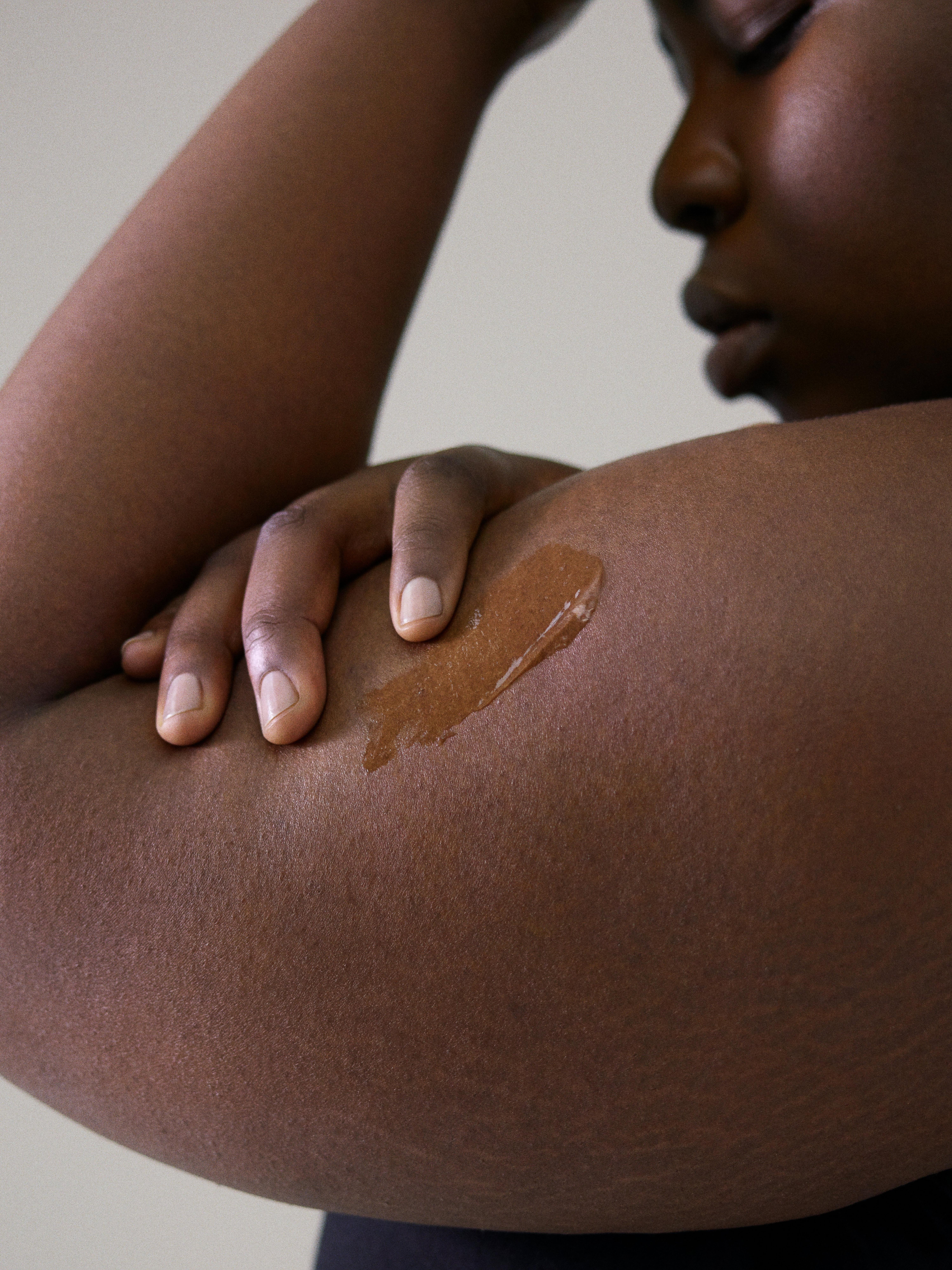 Woman applying body oil