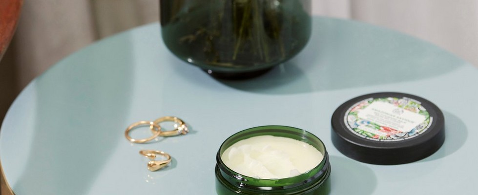 Open pot of face cream on side table Open pot of face cream on side table
