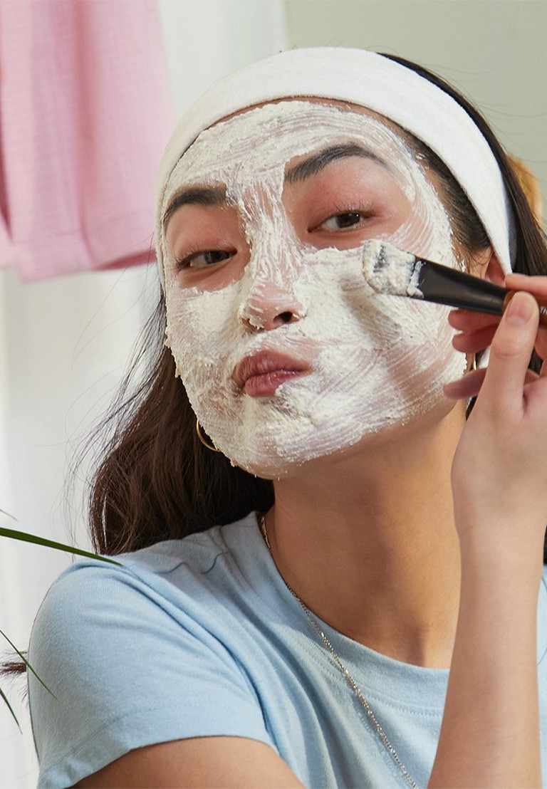 Model applying face mask