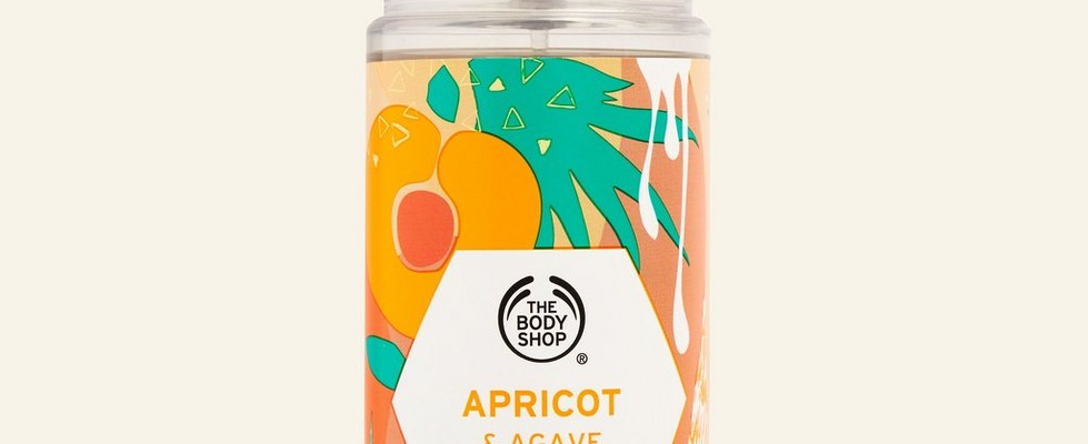 Apricot and agave hair and body mist against beige background Apricot and agave hair and body mist against beige background