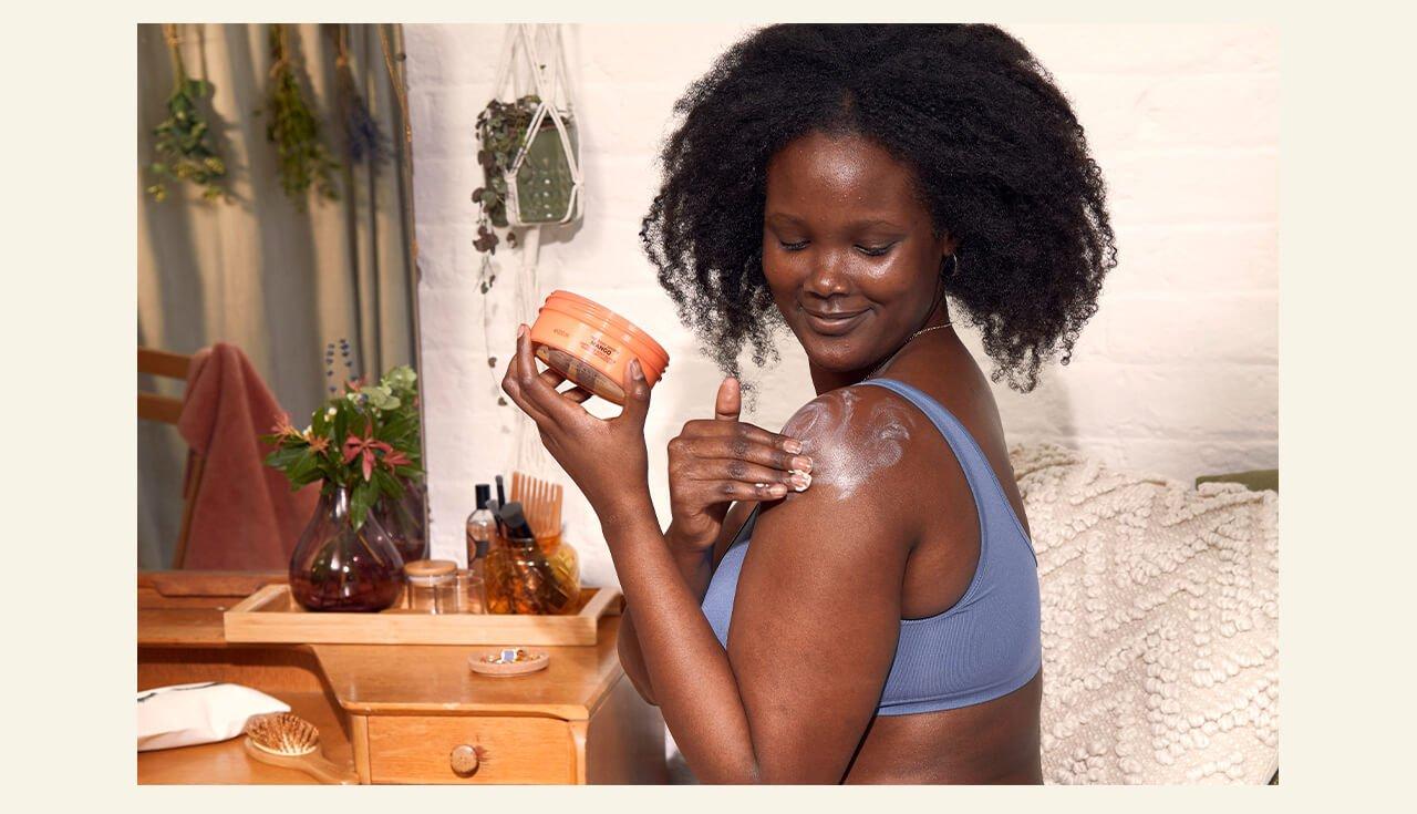 Woman applying body butter
