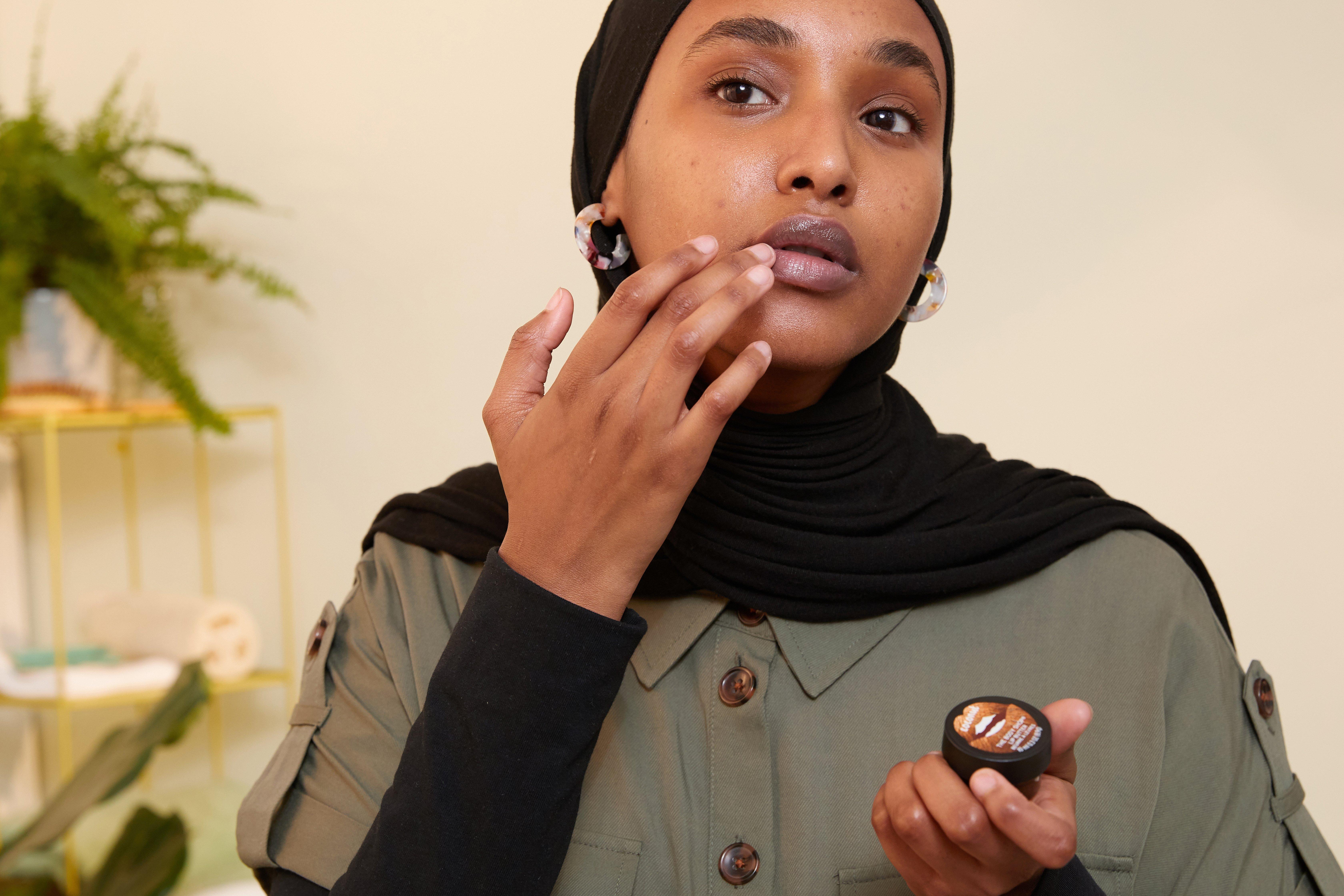 Woman applying lip butter