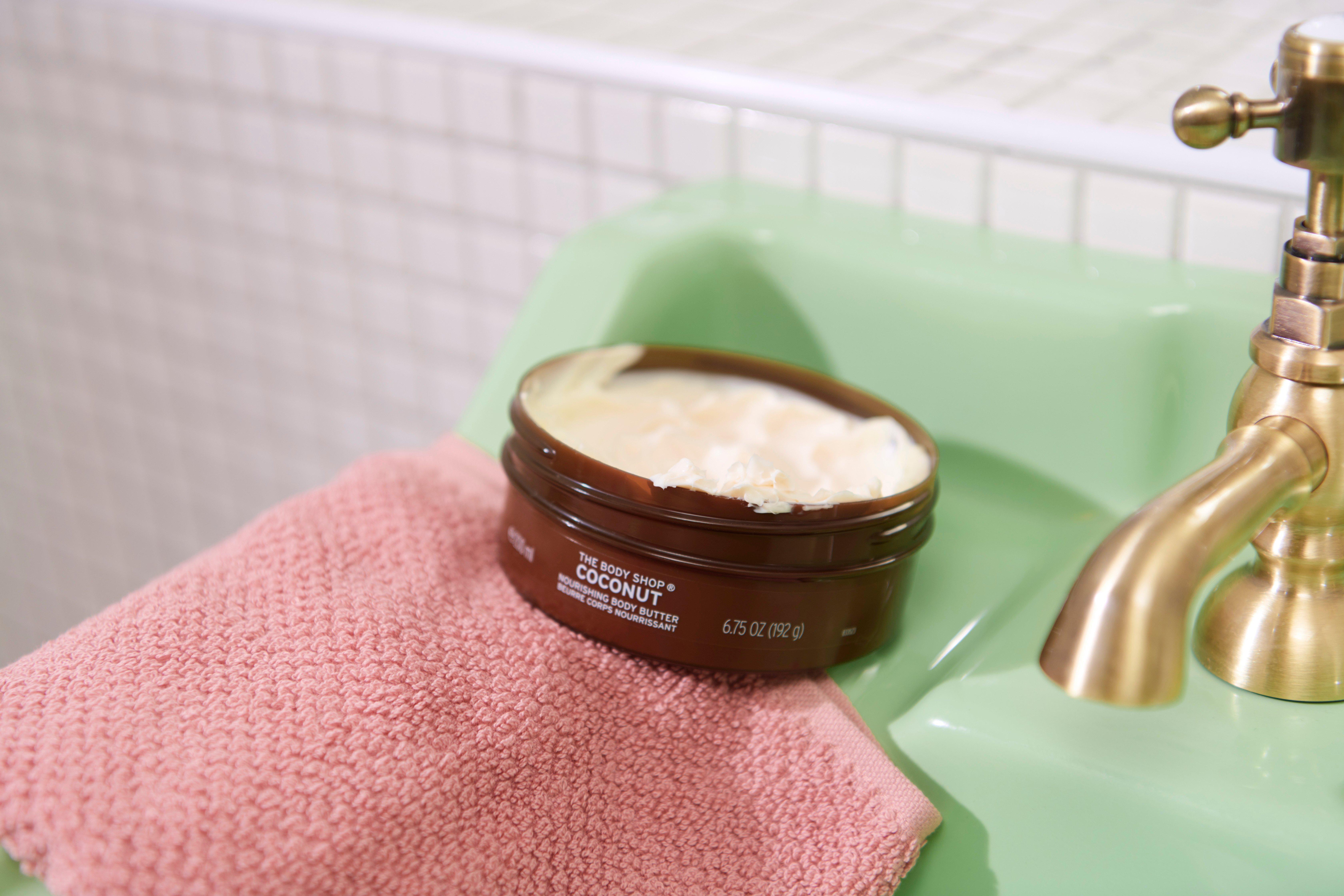 The Body Shop Coconut Body Butter tub on sink