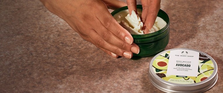 Person scooping Avocado Body Butter Person scooping Avocado Body Butter