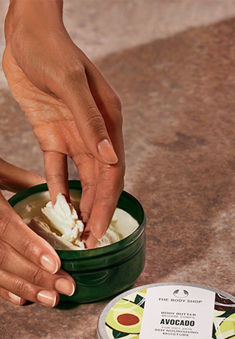 Hand scooping Avocado Body Butter Hand scooping Avocado Body Butter