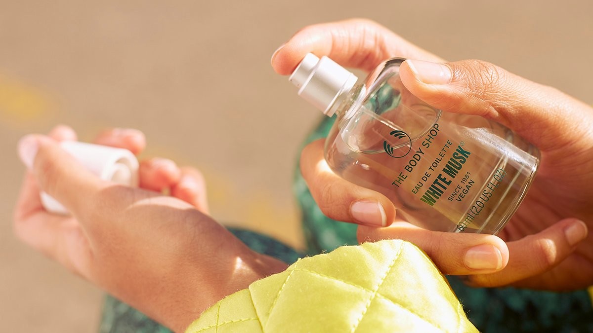 Hands holding bottle of The Body Shop White Musk