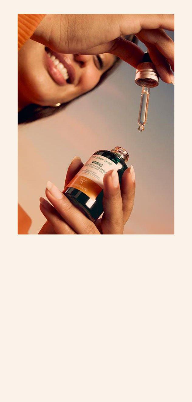 Model holding bottle of Vitamin C serum