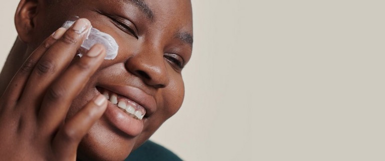 Person applying moisturiser Person applying moisturiser