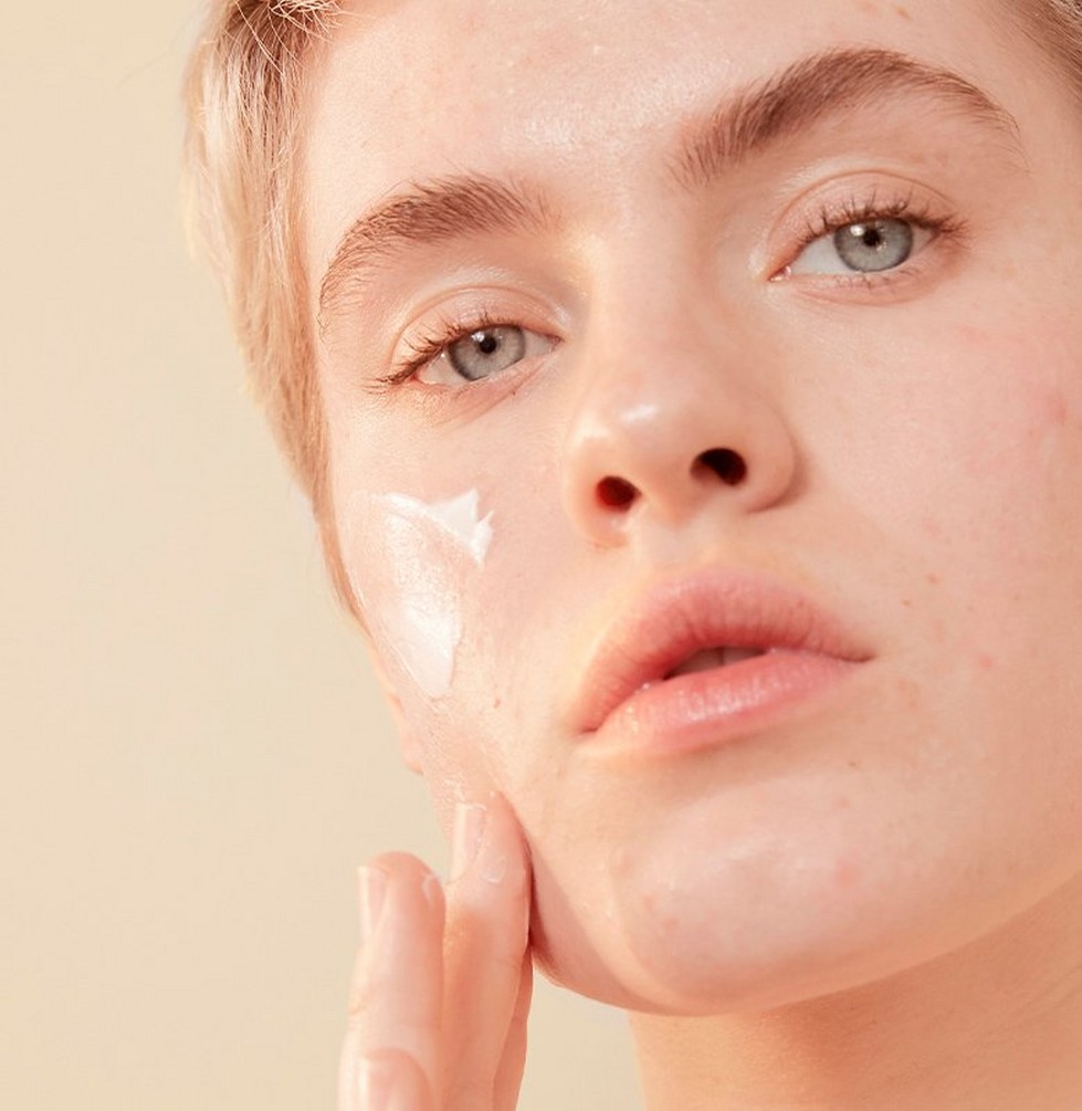 Person applying skincare Person applying skincare