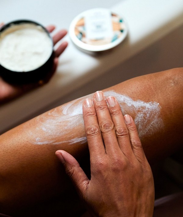 Person applying Body Butter to thigh
