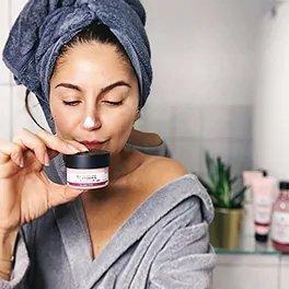 Women Holding Pot Of Bodyshop Vitamin E Moisture Cream